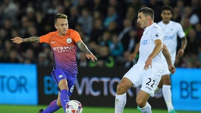 Angelino of Manchester City and Angel Rangel of Swansea City in action during the League Cup third round. Stu Forster / Getty Images