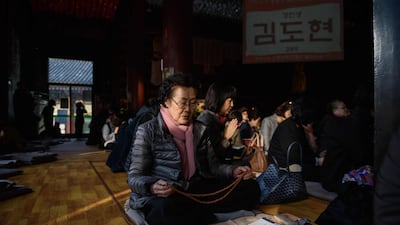 Parents and relatives of students sitting the annual college entrance exams offer prayers at a Buddhist temple in Seoul, South Korea. AFP