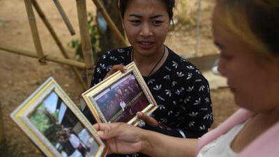 Vendors selling souvenir photos near the entrance of the Tham Luang cave. AFP