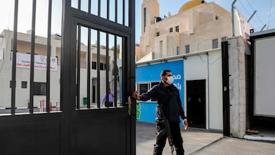 A Palestinian security guard stands at the entrance of a quarantine centre in the West Bank city of Nablus, on March 9, 2020. AFP