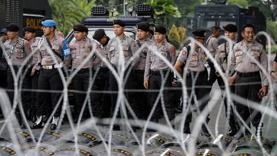 Indonesian police officers stand guard behind razor wires outside of the General Elections Commission (KPU) building in Jakarta, Indonesia. EPA