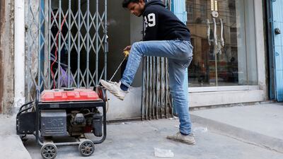 A shopkeeper starts a generator to bring electricity to his store in Karachi. Reuters