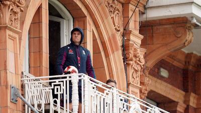 England’s Jason Roy with a football on the players balcony as he watches the rain fall. John Walton / PA Wire