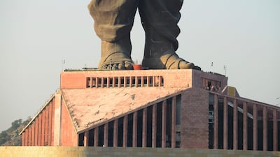 Indian construction workers are seen at the plinth structure the Statue Of Unity. AFP