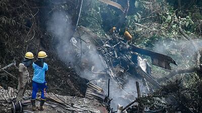 Firemen and rescue workers view the debris of the IAF Mi-17V5 helicopter crash site near Coonoor, in Tamil Nadu. AFP