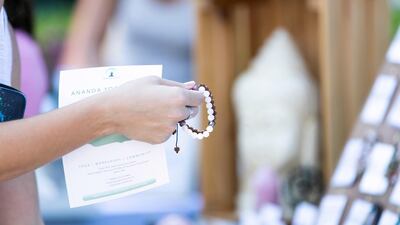 A woman buys a bracelet.