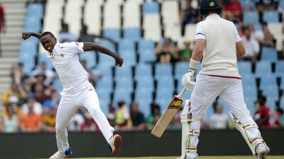 South African bowler Kagiso Rabada, left, celebrates the dismissal of England's batsman Joe Root during Day 3 of the fourth Test match between England and South Africa at the Supersport Stadium on January 24, 2016 in Centurion, South Africa. AFP / GIANLUIGI GUERCIA