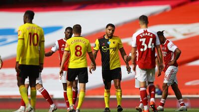 Watford captain Troy Deeney, centre, with teammates and Arsenal players after Watford's relegation from the Premier League. Reuters