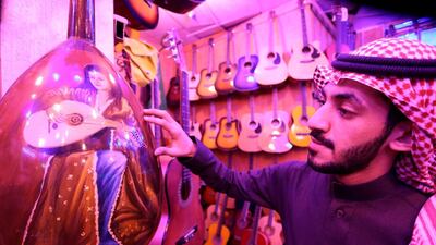 A Saudi musician looks at the design of oud instruments in a music shop at the Hilla market, in Riyadh, Saudi Arabia January 20, 2020. Reuters
