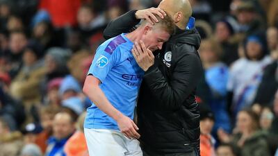 Manchester City manager Pep Guardiola embraces midfielder Kevin De Bruyne as he leaves the pitch. AFP