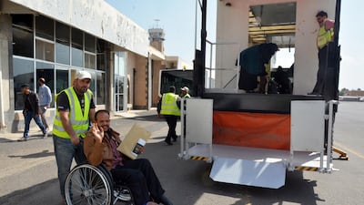 An airport worker pushes a sick Yemeni in a wheelchair before boarding a UN medical evacuation plane at Sana'a airport, Yemen. EPA