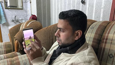 Muthana Al-Najjar with the phone he used to record the video of Israel bulldozer