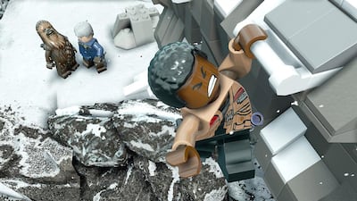 Finn does some climbing while Chewbacca and Han Solo look on in Lego Star Wars: The Force Awakens. Courtesy Warner Bros Interactive Entertainment
