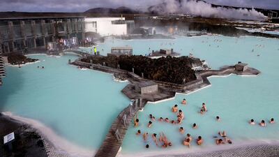 Visitors enjoy the geothermal waters of the Blue Lagoon near Reykjavik. Matt Cardy / Getty Images
