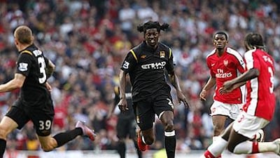 Emmanuel Adebayor runs at the Arsenal defence.