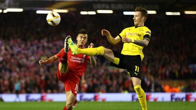 Philippe Coutinho of Liverpool and Marco Reus of Borussia Dortmund compete for the ball. Clive Brunskill / Getty Images