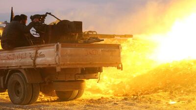 Rebel fighters fire a machine gun on February 17, 2014, at a government forces’ checkpoint on a road leading to Idlib, near the Syrian city of Hama. More than 140,000 people have been killed in three years of fighting, according to the Syrian Observatory for Human Rights. Abu Hadi Al-Hamwi / AFP photo