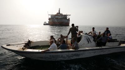 A boat of the Houthis-held coast guard drives past the FSO Safer oil tanker