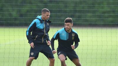 Arsenal's Alex Oxlade-Chamberlain and Kieran Gibbs run drills during the team's training session on Monday in London. Olly Greenwood / AFP