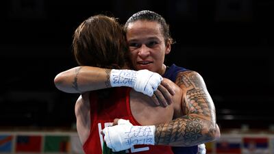 Ireland's Kellie Anne Harrington (red) and Brazil's Beatriz Ferreira hug after their women's light (57-60kg) boxing final bout during the Tokyo 2020 Olympic Games at the Kokugikan Arena in Toky.