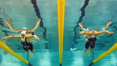 This picture taken with an underwater camera shows French swimmers Coralie Dobral, right, and Fanny Deberghes competing in the women’s 200m breaststroke final on April 13, 2014 during the French swimming championships in Chartres. AFP PHOTO / DAMIEN MEYER