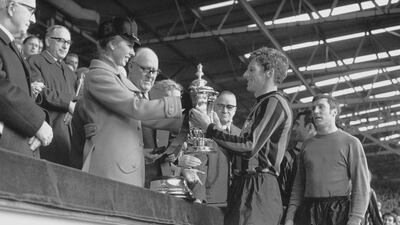 Princess Anne presents the FA Cup to Manchester City captain Tony Book at Wembley Stadium in London in 1969.