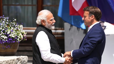 Emmanuel Macron greets India's Prime Minister Narendra Modi during the official welcome ceremony of G7 leaders. AP