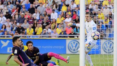 Barcelona’s Uruguayan forward Luis Suarez, left, scores against Las Palmas. Angel Medina G / AFP