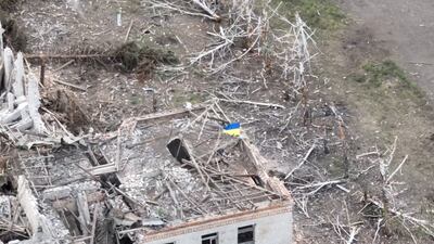 Ukrainian forces raise the national flag in Robotyne