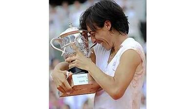 Italy's Francesca Schiavone hugs the winner's trophy after beating Samantha Stosur yesterday.