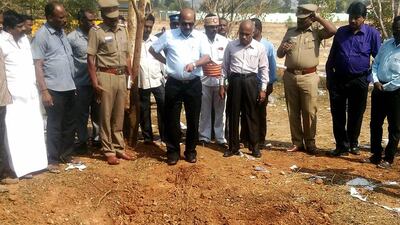 Indian authorities inspect the site of a suspected meteorite landing on February 7, 2016 in Vellore district in southern Tamil Nadu state in an impact that killed a bus driver and injured three others AFP PHOTO