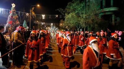 People attend a carnival held in front of al-Sayydah Church in the mostly Christian-populated al-Qassaa neighborhood, Damascus, Syria. EPA