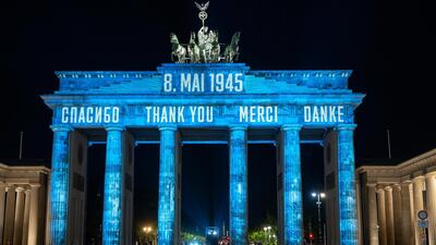In Russian, from left, English, French and German, the Brandenburg Gate is illuminated with the word "Thank you," in Berlin, Germany. May 8th marked the 75th anniversary of the end of World War II in Europe. AP