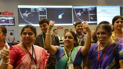 Staff from the Indian Space Research Organisation (Isro) celebrate after the unmanned Mangalyaan successfully entered the Mars orbit on September 24, 2014 after a 10-month journey. Manjunath Kiran / AFP Photo