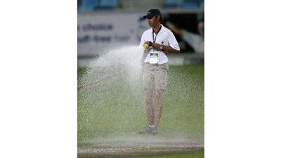 DUBAI, UNITED ARAB EMIRATES - Nov 12 : Ground staff watering the pitch after the first Twenty20 cricket match of Cool & Cool Cup between Pakistan vs New Zealand at Dubai International Cricket Stadium in Dubai Sports City in Dubai. (Pawan Singh / The National) For Sports. *** Local Caption *** PS1211- CRICKETSTOCK050.jpg