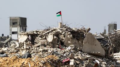 A Palestinian flag flies above destroyed buildings in Rafah, southern Gaza. Reuters