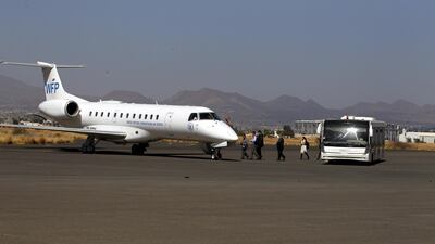 UN aid workers board a plane of the United Nations' World Food Programme (WFP) before leaving Sana'a International Airport. Yahya Arhab / EPA