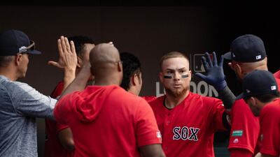 Boston Red Sox catcher Christian Vazquez (7) celebrates with teammates in the dugout after hitting a home run. Reuters