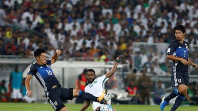 Nawaf Al Abed of Saudi Arabia fights for the ball with Hotaru Yamaguchi of Japan. Faisal Al Nasser / Reuters