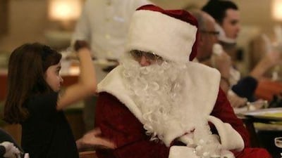 Greta Goedvolk, 6, meets Santa at the Kempinski Hotel, Mall of the Emirates, yesterday. She was disappointed he couldn't give her a pet bunny but said he was still "awesome". Mike Young / The National