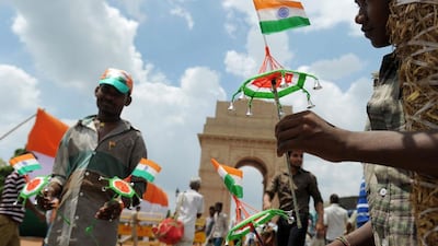 Street vendors sell adornments with the Indian flag at the India Gate monument in New Delhi on August 15, 2012. Roberto Schmidt / AFP Photo