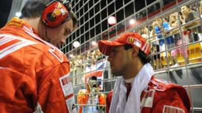 Felipe Massa, right, looks dejected after retiring from the Singapore Grand Prix following a pit-stop blunder. Ferrari bosses say they will use the 'lollipop' system for Sunday's race in Japan.