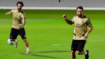 Real Madrid's Spanish midfielder Isco (L) and Real Madrid's Spanish defender Dani Carvajal warm up. AFP