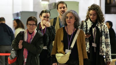 Samuel Paty's sister Gaelle Paty, second right, and his mother Bernadette Paty, left, arrive at the Paris Special Assize Court. AFP