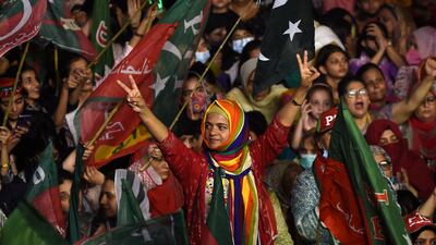 The former cricketer's supporters turned up wearing colourful costumes at the Karachi rally. AFP