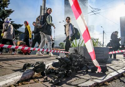 Local residents look at parts of an unmanned aerial vehicle after a Russian attack in Kyiv. Reuters