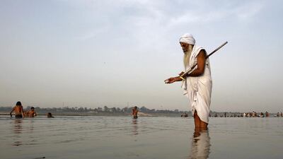 A Hindu holy man offers milk to the waters of the holy river Ganga as part of his morning prayers in Allahabad, India. Jitendra Prakash / Reuters