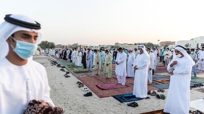 Worshippers attend Eid prayers at the Umm Suquim Eid prayer grounds. Antonie Robertson / The National
