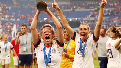 Rapinoe celebrates with the trophy. Reuters