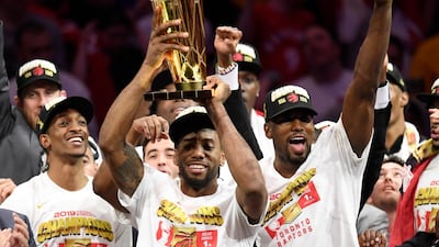 Toronto Raptors forward Kawhi Leonard, centre, holds the Larry O'Brien NBA Championship Trophy after the Raptors defeated the Golden State Warriors 114-110 in Game 6 of the NBA Finals, in Oakland, California. AP Photo